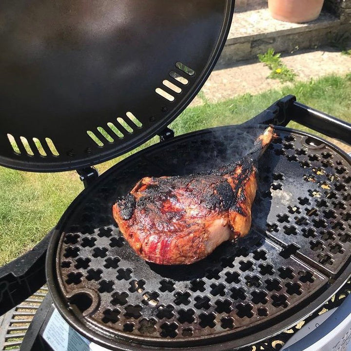 A cooked David Moore’s Tomahawk Steak on a BBQ grill.