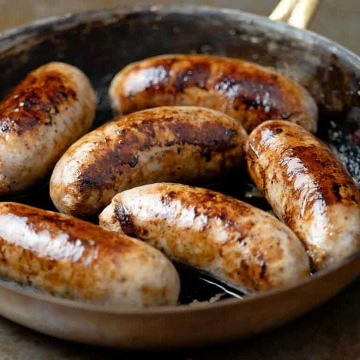 A pan of six cooked David Moore's sausage meat.