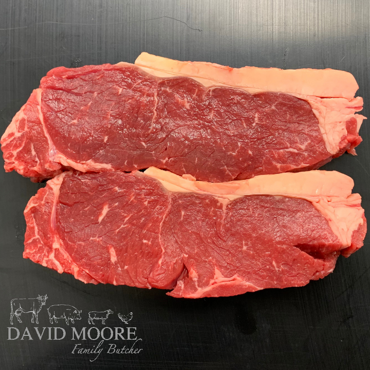 Two raw David Moore's sirloin steaks.