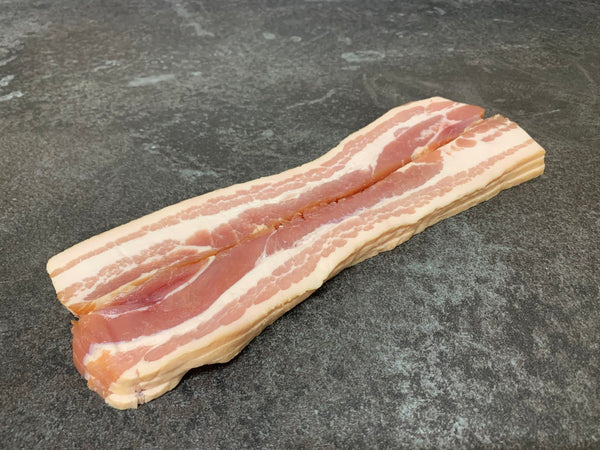 Raw stack of David Moore's streaky bacon. 