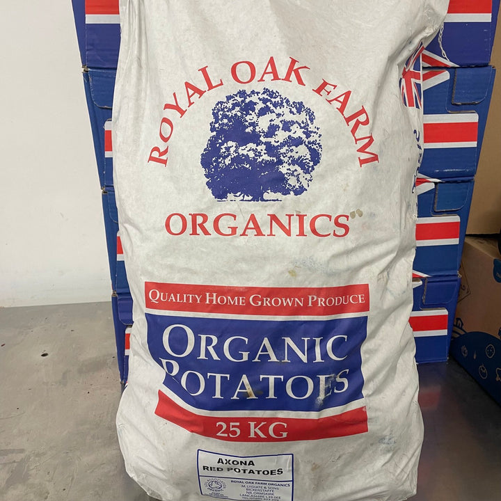 A white paper bag labeled 'Royal Oak Farm Organics' Qualoty Home Grown Produce, Organic Potatoes. Axona Red Potatoes. 25kg.