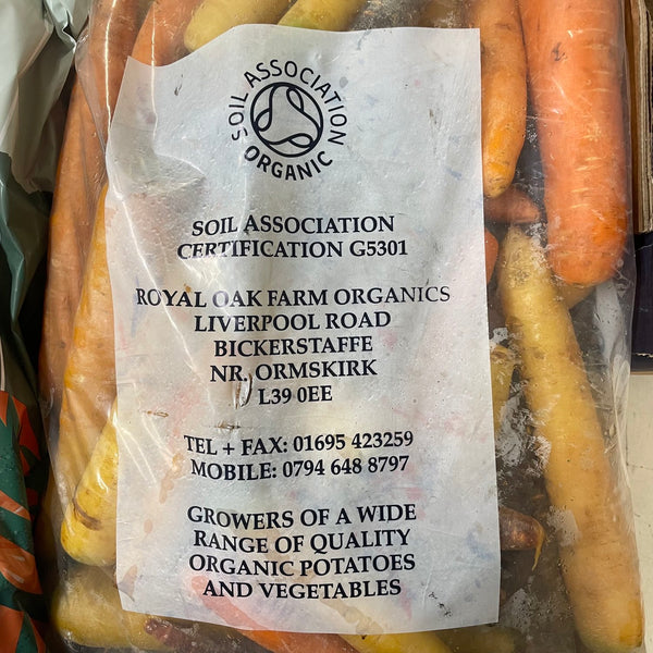 A clear bag of Organic Rainbow Carrots with a label from Royal Oak Farm Organics.