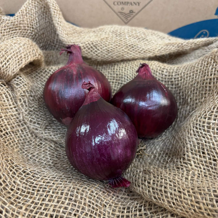 A trio of red onions.